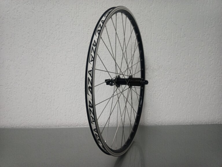 Roue arrière / 559X19C / Rigida - Ryde / ZAC 2000 / Noir / Shimano / FH-T4000 Alivio / HG Body 35 MM / 135 MM / Frein sur jante / VTT - Tour